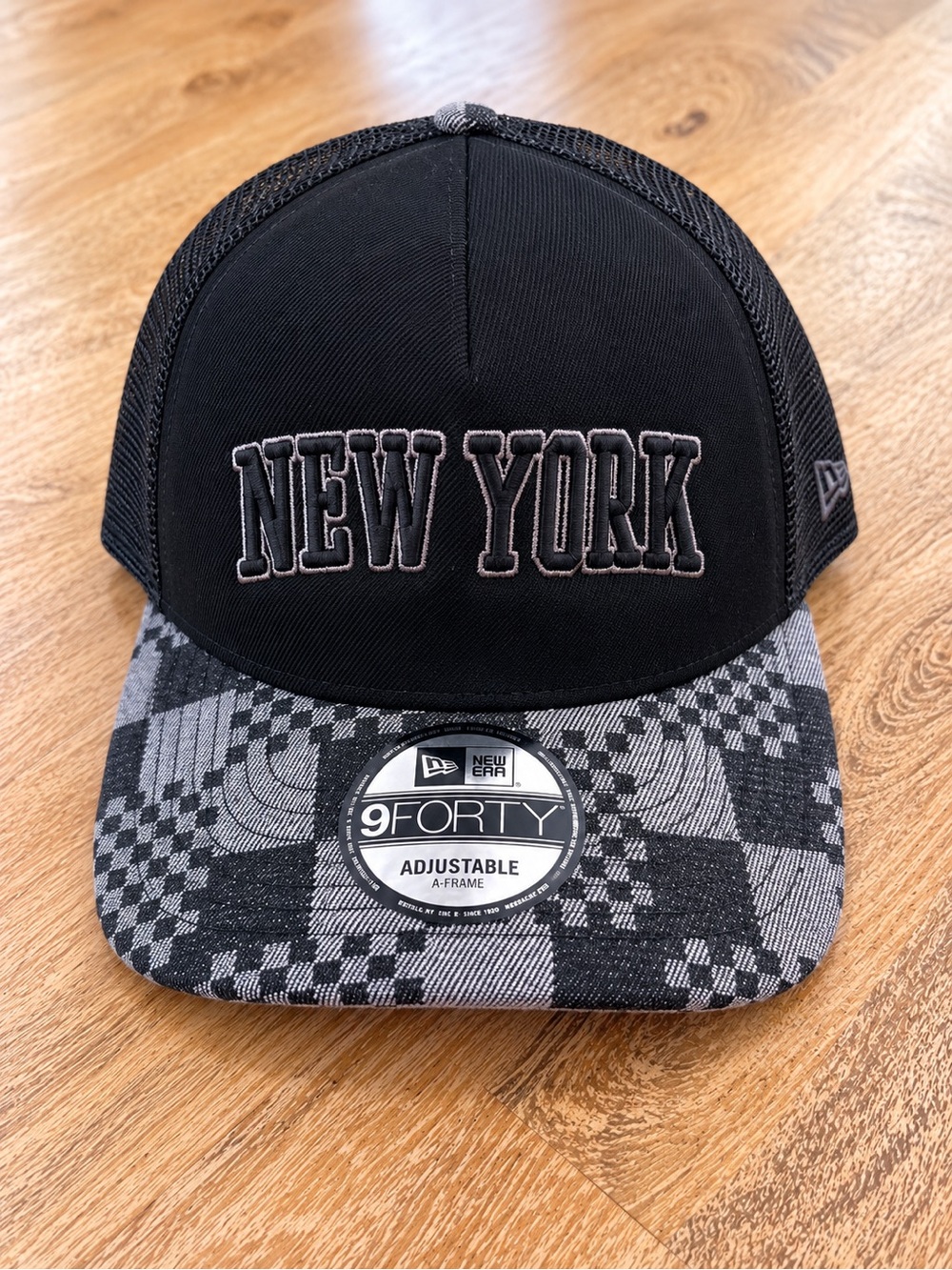 New Era Black Mesh Trucker Cap with Logo Tag